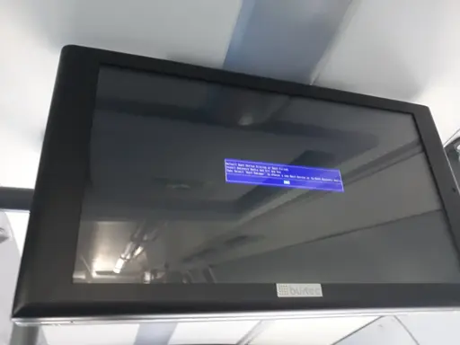 "Next stops" screen mounted in bus by the company "bustec". Shows black with blue window with white text: "Default Boot Device Missing or Boot Failed. / Insert Recovery Media and Hit any Key / Then select 'Boot Manager' to choose a new Boot Device or to Boot Recovery Media". Button selected in teal: [OK]