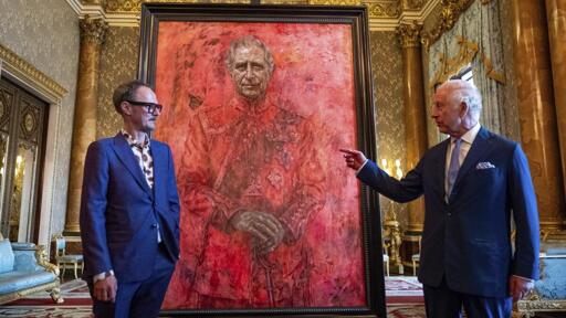 King Charles of the United Kingdom and artist who commissioned a portrait of him standing in front of said portrait